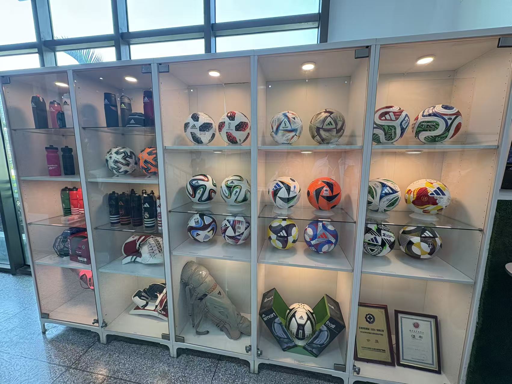 图为:阿迪达斯东莞代工工厂内展示的比赛用球和运用护具(记者 杨溢仁).jpg 76af287f8ecd4c808e445b9e55030054.jpeg